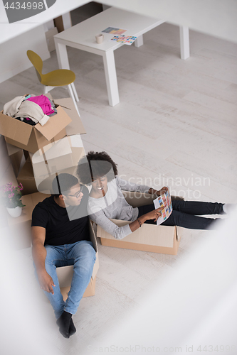 Image of African American couple  playing with packing material