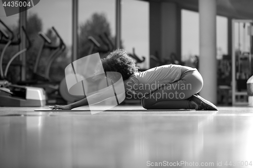 Image of african american woman exercise yoga in gym