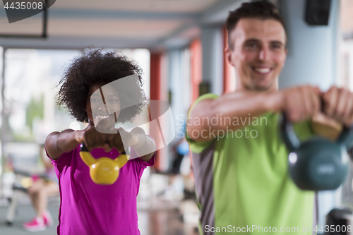 Image of couple  workout with weights at  crossfit gym