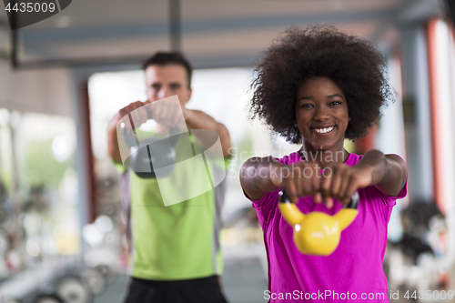 Image of couple  workout with weights at  crossfit gym