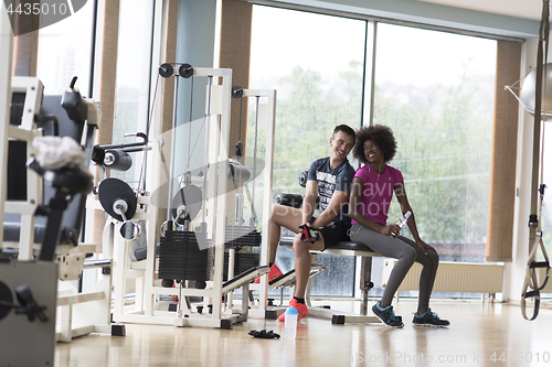 Image of couple in a gym have break