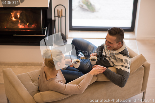 Image of Young couple  in front of fireplace