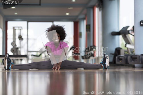 Image of woman in a gym stretching and warming up before workout