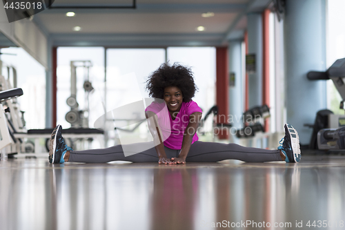 Image of woman in a gym stretching and warming up before workout