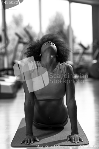 Image of african american woman exercise yoga in gym