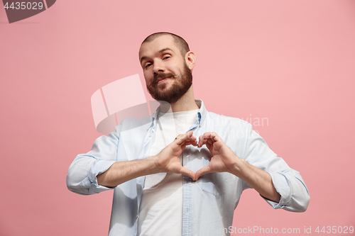 Image of Portrait of attractive man with kiss isolated over pink background