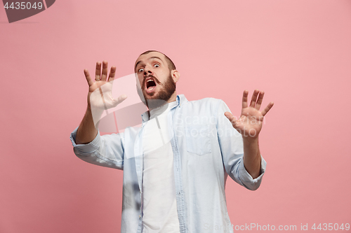 Image of Portrait of the scared man on pink