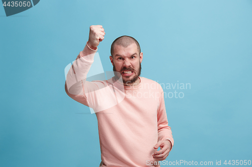 Image of The young emotional angry man screaming on pink studio background