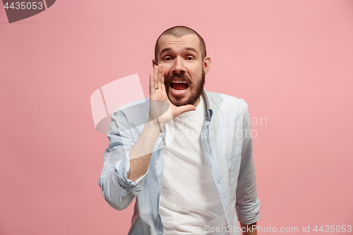 Image of Isolated on pink young casual man shouting at studio