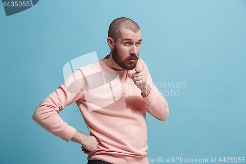 Image of Suspiciont. Doubtful pensive man with thoughtful expression making choice against pink background