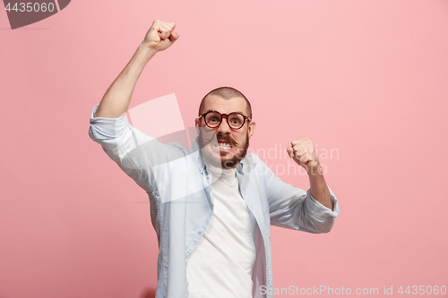 Image of The young emotional angry man screaming on pink studio background