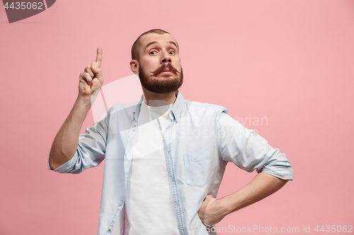 Image of Young serious thoughtful businessman. Doubt concept.