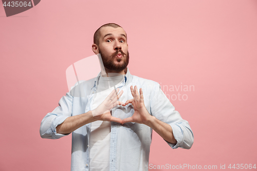 Image of Portrait of attractive man with kiss isolated over pink background