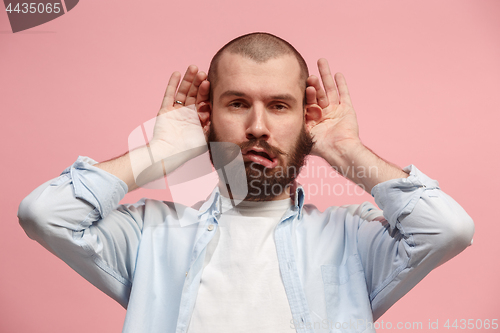 Image of The squint eyed man with weird expression isolated on pink