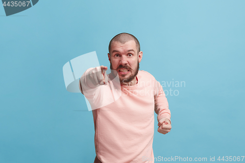 Image of The overbearing businessman point you and want you, half length closeup portrait on blue background.