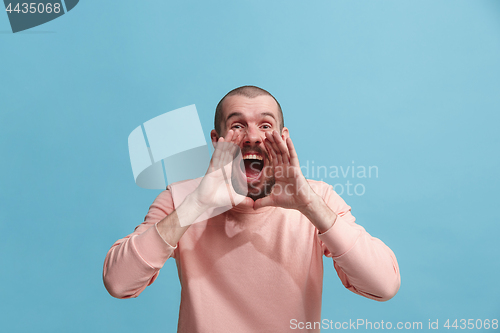 Image of Isolated on pink young casual man shouting at studio