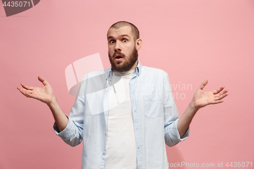 Image of Let me think. Doubtful pensive man with thoughtful expression making choice against pink background