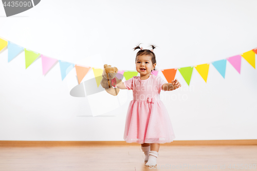 Image of happy baby girl with teddy bear on birthday party