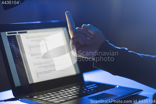 Image of hacker showing middle finger to laptop