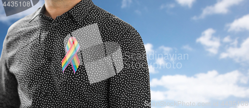 Image of man with gay pride rainbow awareness ribbon