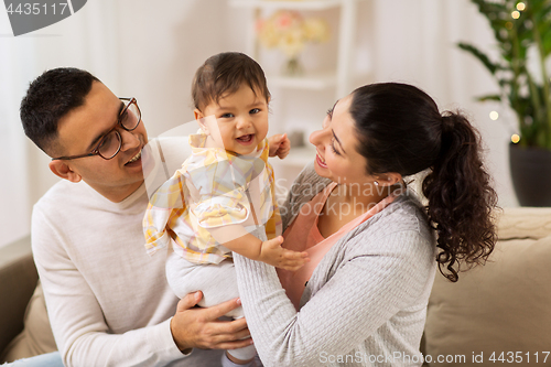 Image of happy family with baby daughter at home