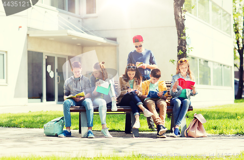 Image of group of students with notebooks at school yard