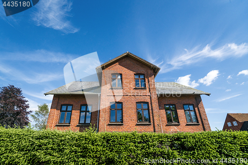 Image of Large brick house in red color