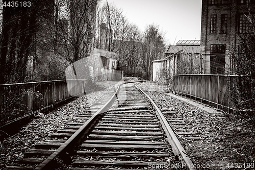 Image of Railroad tracks going through an abandoned city