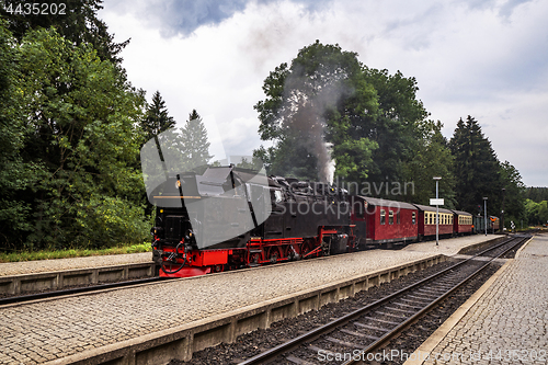 Image of Old steam locomotive leaving the train station