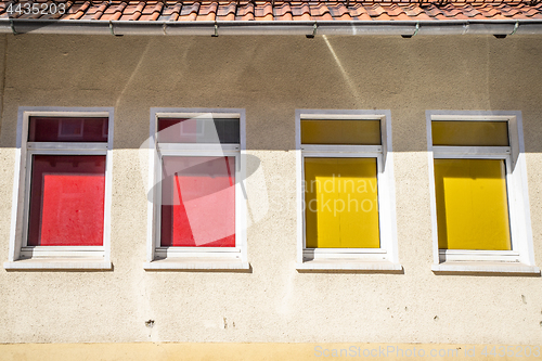 Image of Four colorful windows on a building