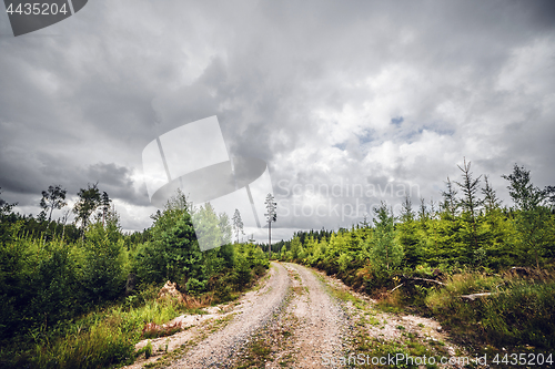 Image of Cloudy weather over a dirt road