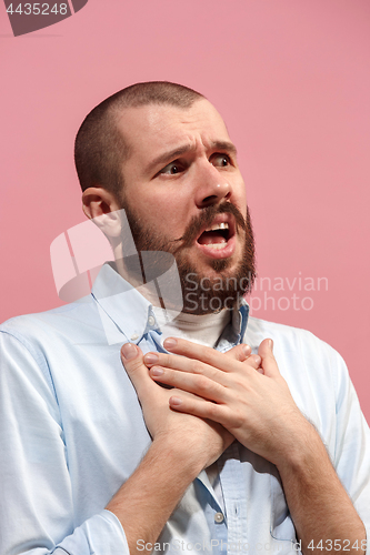 Image of Isolated on pink young casual man is boring at studio