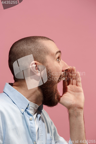 Image of Isolated on pink young casual man shouting at studio