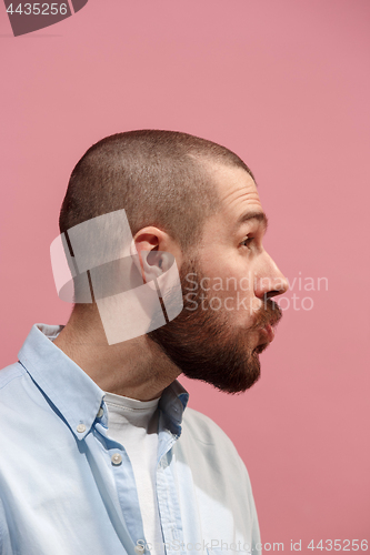 Image of Isolated on pink young casual man is gossiping at studio