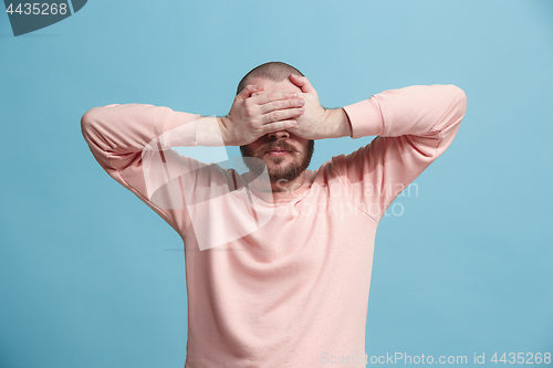 Image of man covered his face with his hands