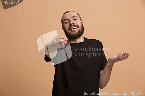 Image of The happy business man point you and want you, half length closeup portrait on pastel background.