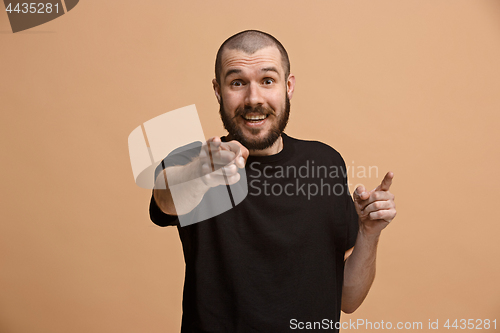 Image of The happy business man point you and want you, half length closeup portrait on pastel background.