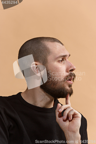 Image of Young serious thoughtful businessman. Doubt concept.