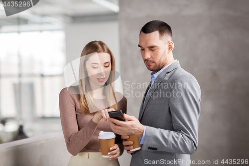 Image of businesswoman and businessman with smartphone