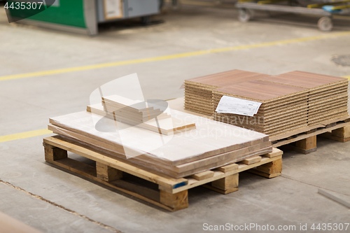 Image of wooden boards and chipboards storing at factory