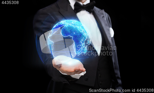 Image of close up of magician with earth hologram