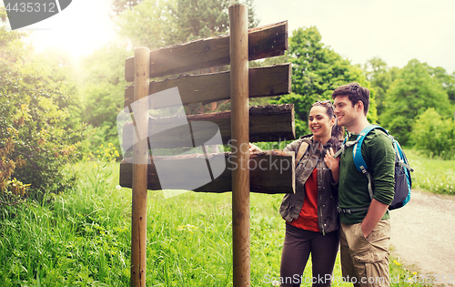 Image of smiling couple with backpacks hiking