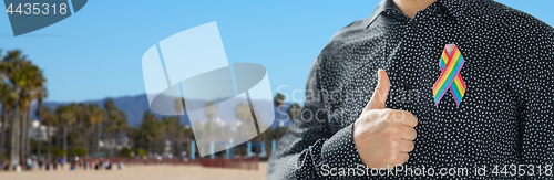 Image of man with gay pride rainbow awareness ribbon