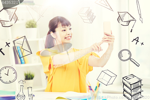 Image of asian woman student taking selfie with smartphone