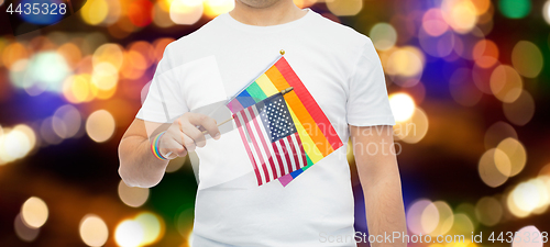 Image of man with gay pride rainbow flag and wristband