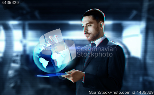 Image of businessman with transparent tablet and earth