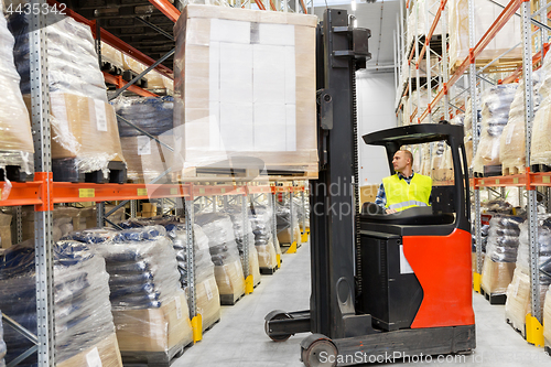 Image of loader operating forklift at warehouse