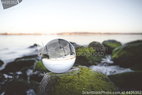 Image of Crystal ball on moss covered rocks