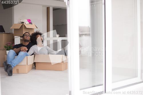 Image of African American couple  playing with packing material