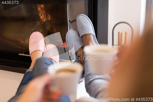 Image of Young multiethnic couple  in front of fireplace